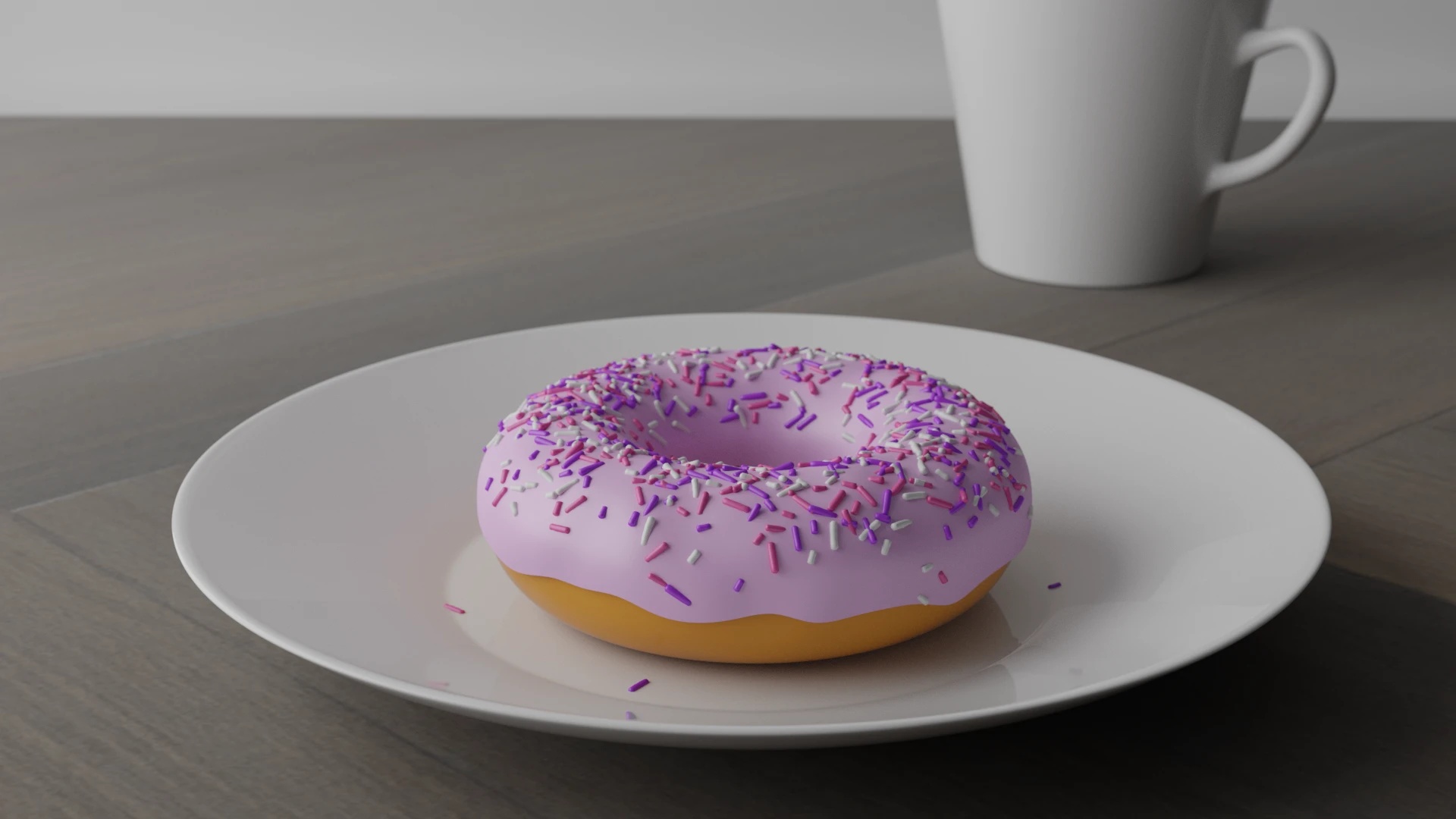 Donut covered with pink glaze and white, pink and purple sprinkles lays on a shiny white ceramic plate. Behind the plate, on the right hand side there is a white shiny ceramic coffee mug. Both the plate and the mug sit on a dark brown wooden table.