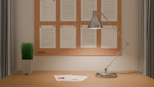 a desk with documents and a desk-lamp on it
